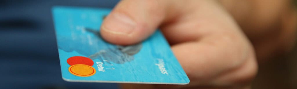 person holding credit card in hand