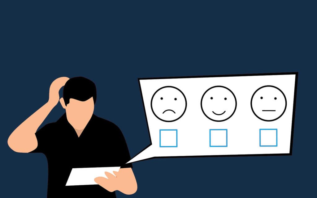 Man looking at a tablet deciding between three ratings from happy to unhappy.