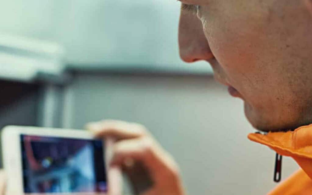 A field technician looking at a mobile screen.