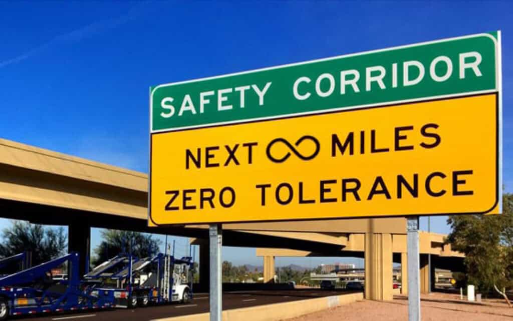A road sign with text reading, "Safety Corridor. Next Infinite Miles Zero Tolerance."