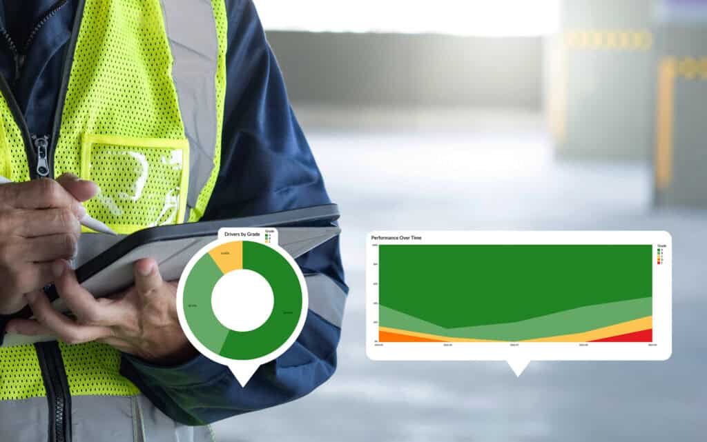 Person in safety vest looking at a tablet with charts and graphs.