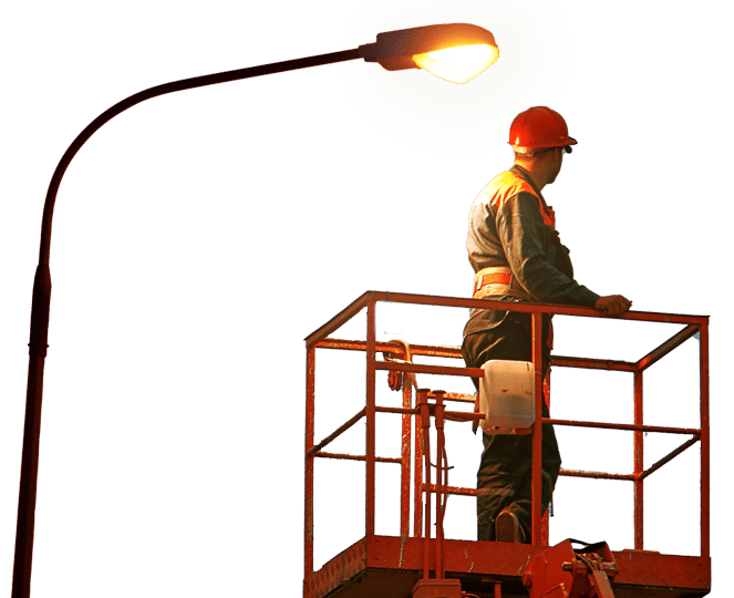 a man in a bucket lift going to fix a street light